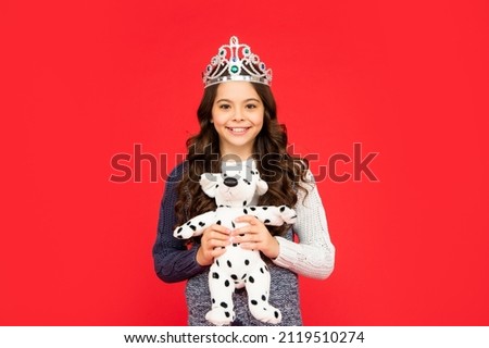 happy child in queen crown. princess in tiara. kid hold toy.