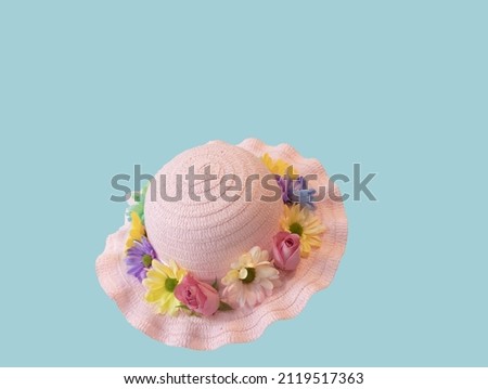 Make Your Own Easter Bonnet with Fresh Flowers. Be great for kids to dress up as the queen for the Platinum Jubilee with these. Straw hat with fresh flowers and ribbon as decoration.  Royalty-Free Stock Photo #2119517363