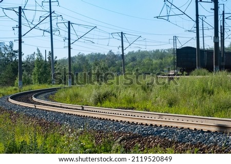 turn of the railway road in the forest, outgoing freight train. landscape with train