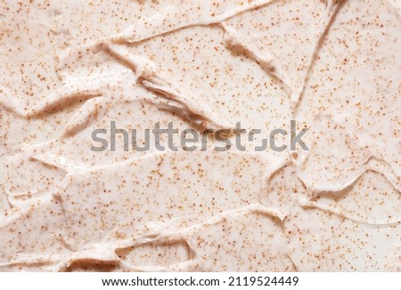 Irregular pattern of creamy organic scrub with brown grains professional skincare product as background close view from above Royalty-Free Stock Photo #2119524449