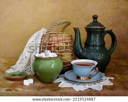 Still life with a cup of tea and a kettle.Cozy atmosphere of the kitchen. Royalty-Free Stock Photo #2119524887