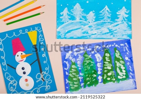 Collage of children's Christmas drawing. Application of children's creativity. Kindergarten and craft school. The child painted a winter Christmas tree and a snowman.