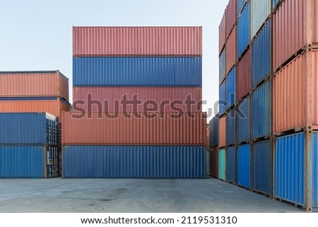 Stack of containers in a harbor. Shipping containers stacked on cargo ship. Background of Stack of Containers at a Port. Royalty-Free Stock Photo #2119531310