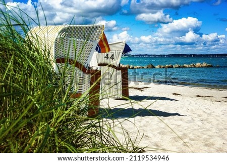 Relaxing on the beach - ocean with beach chairs Royalty-Free Stock Photo #2119534946