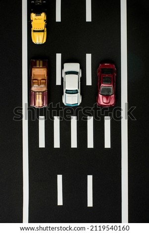 miniature vehicles waiting at pedestrian crossing in traffic