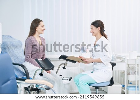 Patient communicating with gynecologist during private medical consultation Royalty-Free Stock Photo #2119549655