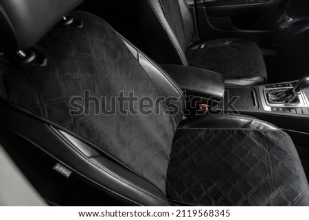 fabric seat cover in a car in a black interior Royalty-Free Stock Photo #2119568345
