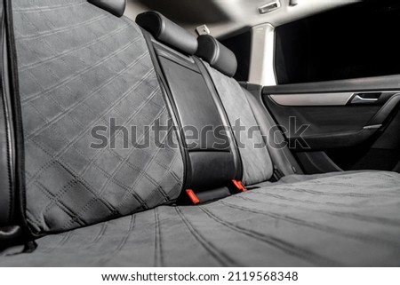 fabric seat cover in a car in a black interior Royalty-Free Stock Photo #2119568348