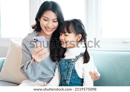 image of mother and daughter cuddling on the sofa