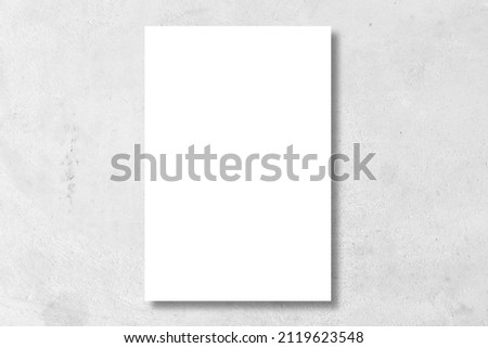 blank white poster on white color cement wall background for interior design concept