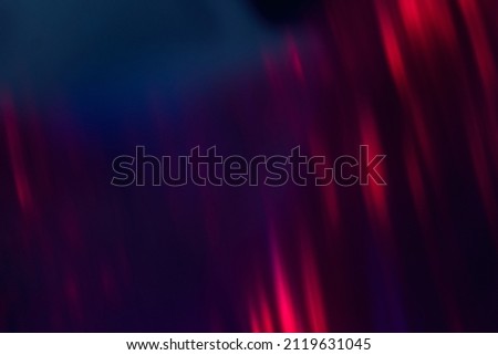 Blur neon background. Color glow. Light flare. Bokeh sparks texture. Defocused blue red purple flecks rays on dark abstract overlay. Royalty-Free Stock Photo #2119631045