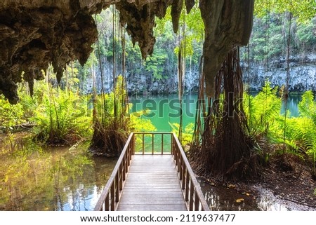 Three eyes cave in Santo Domingo, los Tres Ojos national park, Dominican Republic. Scenic view of limestone cave, beautiful lake and tropical plants, nature landscape, outdoor travel background Royalty-Free Stock Photo #2119637477