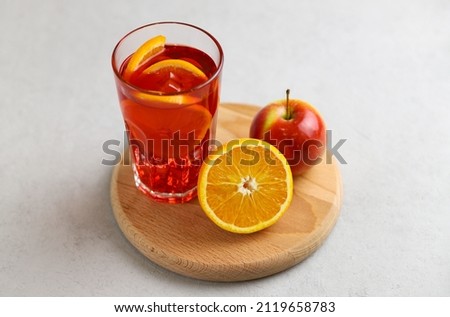 Spanish drink sangria with fruit and ice cubes on a gray background. Selective focus. 