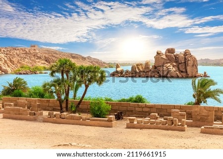 Rocks in lake Nasser of the Nile river near Philae temple, Aswan, Egypt Royalty-Free Stock Photo #2119661915