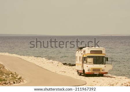 Retro van by the sea on the old vintage photo filter