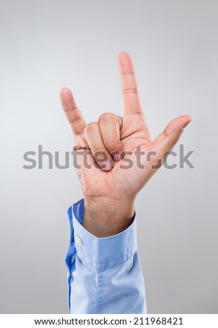 Businessman hand give peace sign