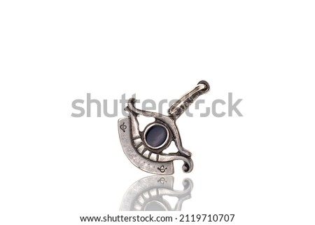 One silver All-Seeing Eye pendant, macro, isolated on a white background.