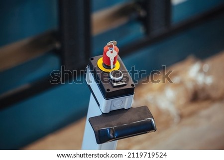 Key switch and start button of industrial machinery, close up.