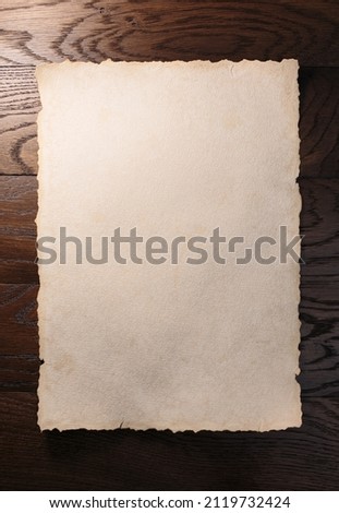 Old aged paper or scroll on wooden table.