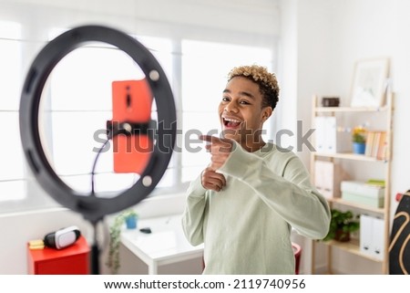 Young male creator recording online media video on his room - Millennial guy streaming online and sharing social media content by mobile phone app network - New trends for millennial people concept Royalty-Free Stock Photo #2119740956