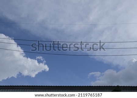 Blue sky and clouds. Beautiful cloudscape over horizon Beautiful landscape with shiny light blue sky High voltage transmission substation on dark blue sky background, industrial aerial photography