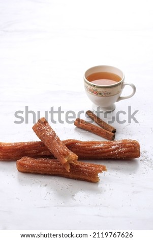 Selected Focus Churros with Cinnamon Sugar and a Cup of Tea, Copy Space for Text