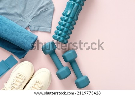 Female fitness flat lay, sneakers, dumbbells, on pastel pink background.Feminine sports, workouts, healthy lifestyle. Royalty-Free Stock Photo #2119773428