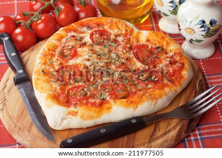 Heart shaped pizza margherita with cherry tomato and cheese