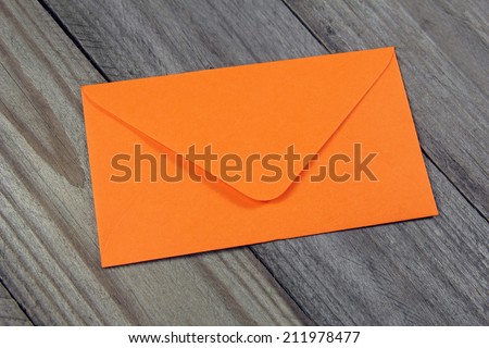 orange envelope on wooden background