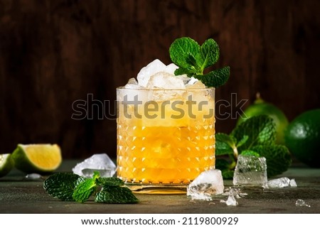 Mai Tai trendy alcoholic cocktail with rum, liqueur, syrup, lime juice, mint and crushed ice. Dark background, copy space Royalty-Free Stock Photo #2119800929