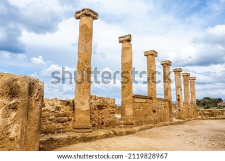 Ruins of an ancient temple in Paphos. Remains of carved marble columns. A row of seven columns as a visiting card of Cyprus. Royalty-Free Stock Photo #2119828967