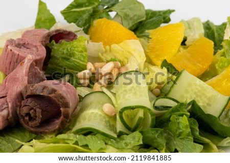 Smoked beef salad with Orange. salad citrus lettuce, mix leaves, tangerine. Royalty-Free Stock Photo #2119841885