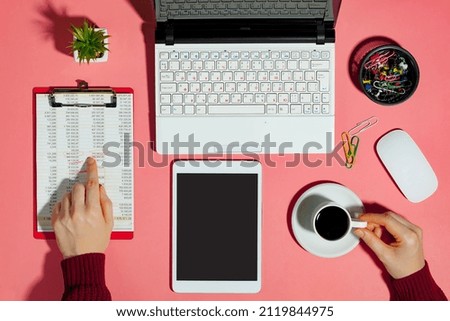 Female hands with items for doing business on a bright colored background