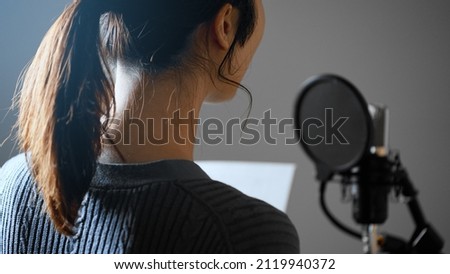 Image of a young voice actor doing post recording.