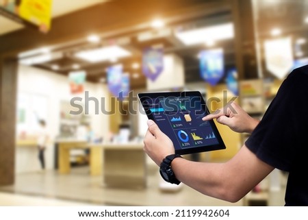 Smart store management systems concept.Manager using digital tablet on blurred store as background Royalty-Free Stock Photo #2119942604