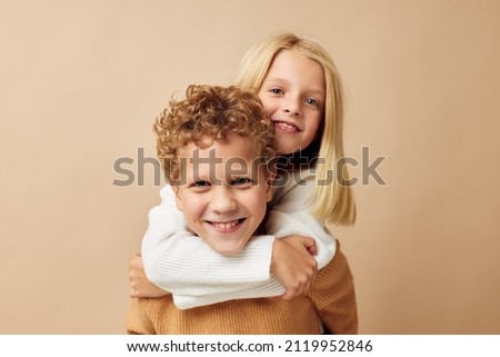 Boy and girl standing next to posing emotions Lifestyle unaltered