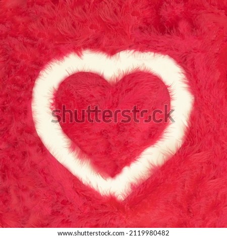 Creative flat lay composition with heart shaped picture frame in colorful soft feather nest. Realistic aesthetic look background. Contemporary style.
