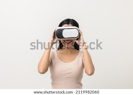 Young asian woman put on vr glasses into virtual simulated world. Future technology cyber universe. Enjoying an Experiences of Virtual World. Attractive asian woman on isolated white background