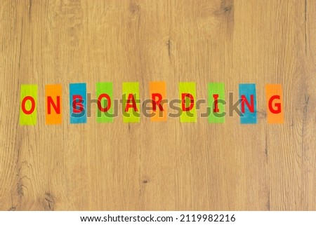 Onboarding success symbol. The concept word Onboarding on colored papers on a beautiful wooden background. Business and onboarding success concept, copy space.