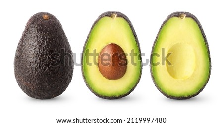 Isolated avocados. Whole black avocado fruit, half with seed and a half without isolated on white background with clipping path Royalty-Free Stock Photo #2119997480