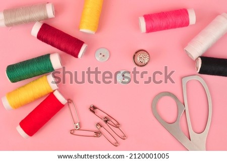 Equipment for sewing on pink background copy space. High quality photo