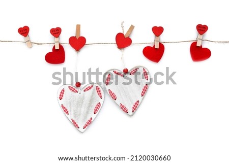 Clothespins with red hearts on rope isolated on white background. Top view. Greeting card. Space for your text