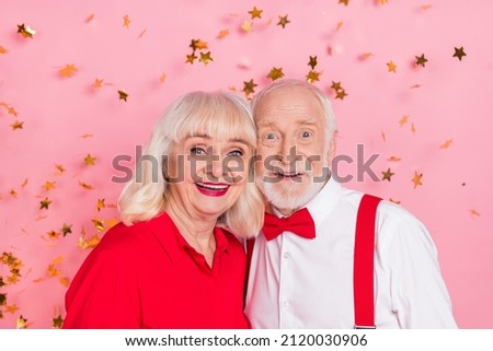 Portrait of attractive trendy cheerful chic gray-haired couple having fun bonding isolated over pink pastel color background