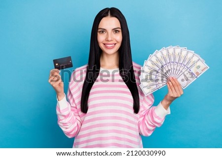 Photo of youth pretty girl rich credit card cash finance income salary isolated over blue color background