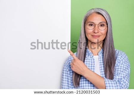 Photo of smart old grey hairdo lady index promo wear spectacles checkered shirt isolated on green color background