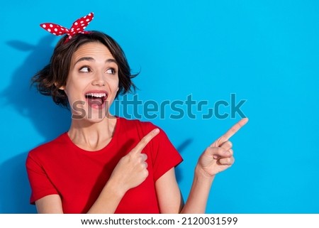 Photo of cool millennial brunette lady look promotion wear red t-shirt band isolated on blue color background