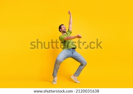 Full size profile side photo of young man have fun ride horse look empty space isolated over yellow color background Royalty-Free Stock Photo #2120031638