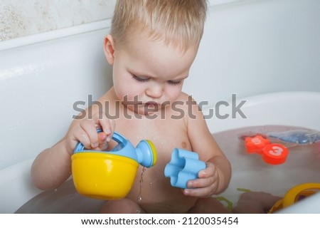Toddler boy bathes in bathroom close-up.