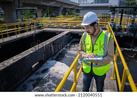 Engineer take water from  wastewater treatment pond to check the quality of the water. After going through the wastewater treatment process. Royalty-Free Stock Photo #2120040551