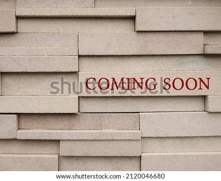 Wall with text COMING SOON, to inform something imteresting will be arriving in the near future